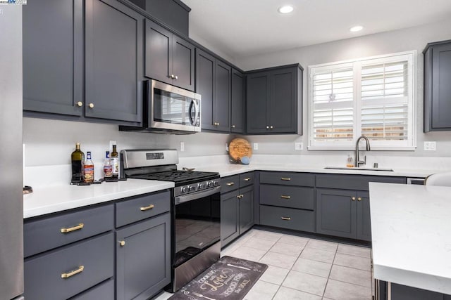 kitchen with light tile patterned floors, stainless steel appliances, and sink