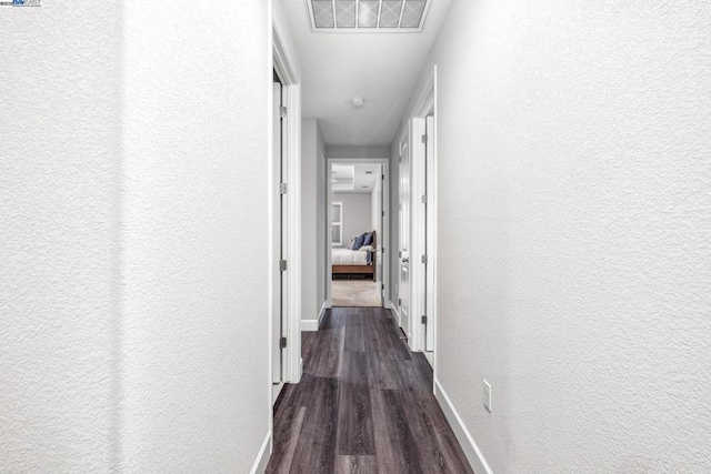 hall with dark hardwood / wood-style floors