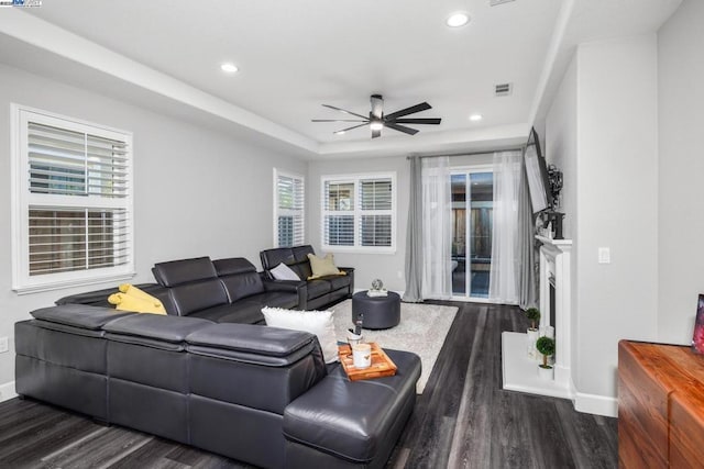 living room with ceiling fan, a healthy amount of sunlight, and dark hardwood / wood-style flooring