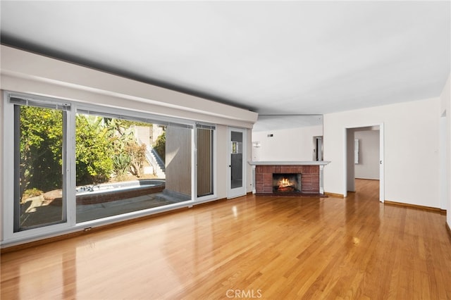 unfurnished living room with a fireplace and hardwood / wood-style flooring