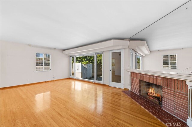 unfurnished living room with wood-type flooring and a fireplace