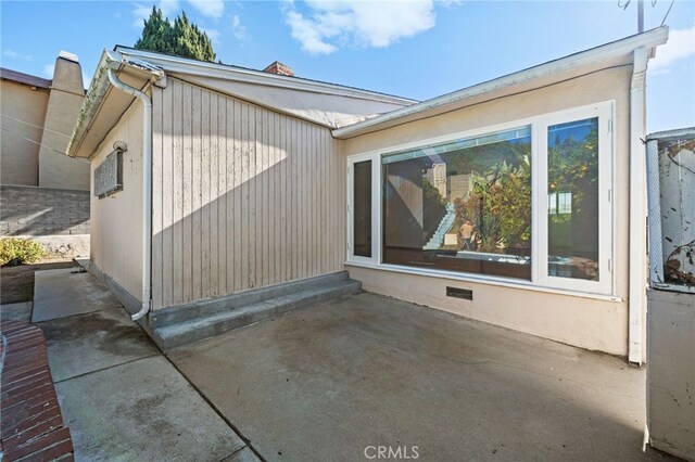 view of side of home with a patio area