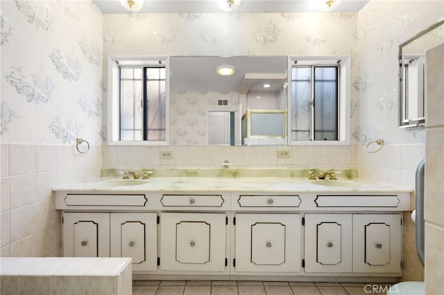 bathroom featuring tile walls, tile patterned floors, and vanity