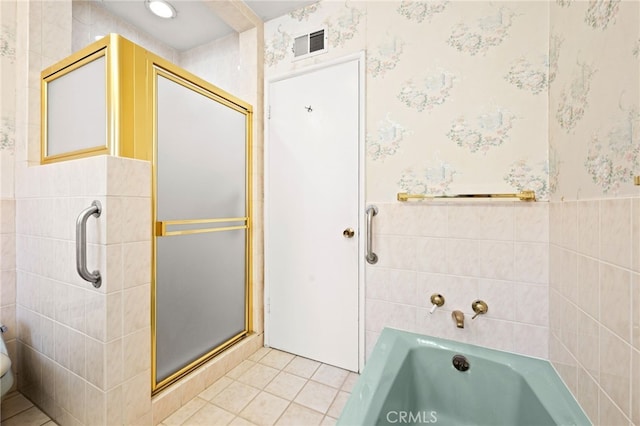 bathroom with tile patterned floors and independent shower and bath