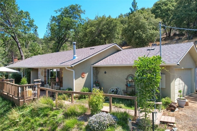 back of house featuring a garage