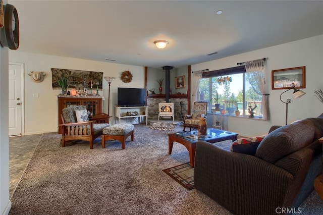 carpeted living room featuring a wood stove