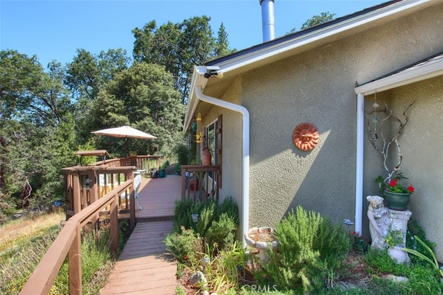 view of property exterior with a wooden deck