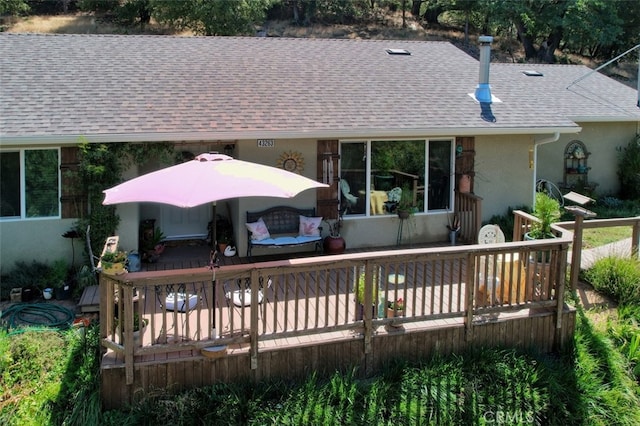 back of house featuring a wooden deck