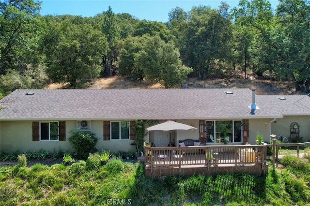 rear view of house featuring a deck