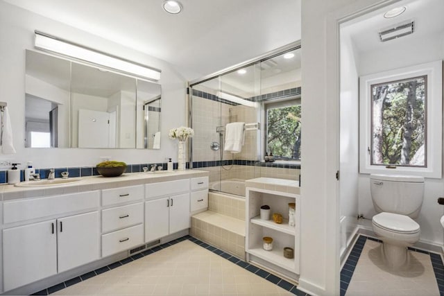 full bathroom featuring toilet, tile patterned floors, vanity, and independent shower and bath