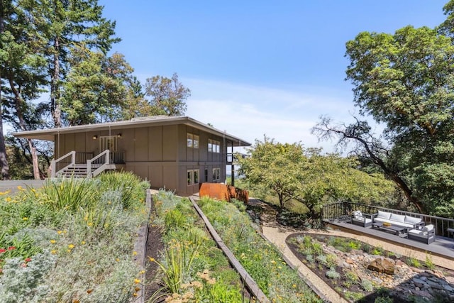 view of property exterior with an outdoor hangout area