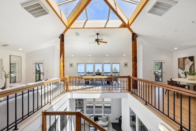 corridor with lofted ceiling with skylight