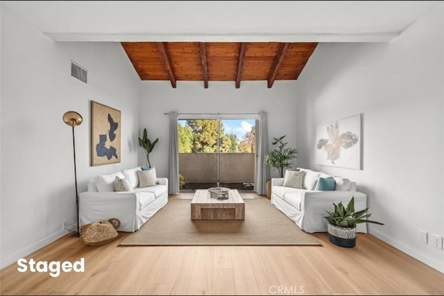 living room featuring hardwood / wood-style floors, wood ceiling, and vaulted ceiling with beams