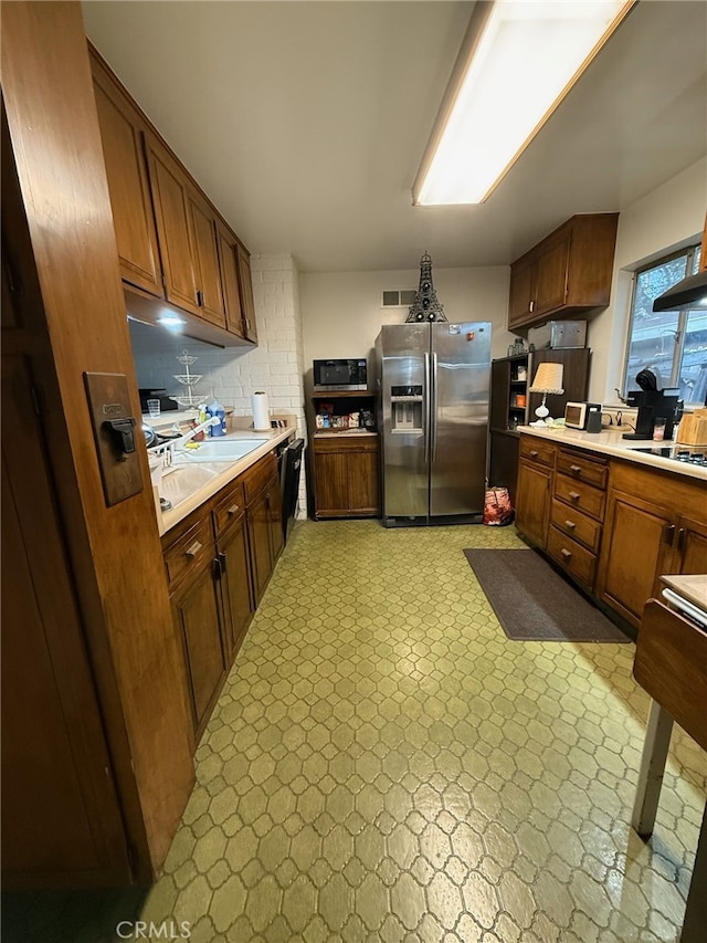 kitchen with stainless steel refrigerator with ice dispenser and dishwasher