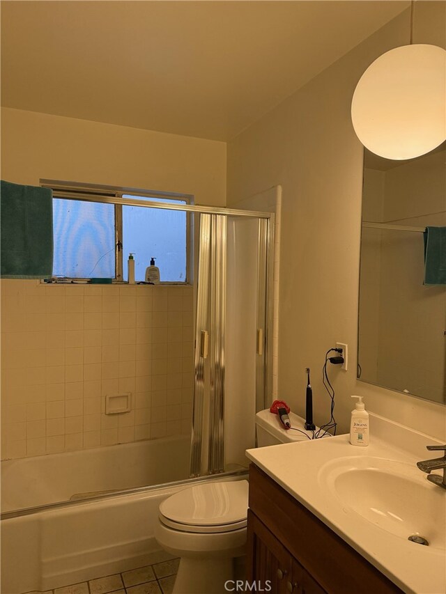 full bathroom with toilet, vanity, tile patterned floors, and combined bath / shower with glass door