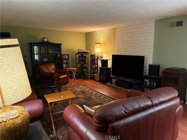 living room featuring a textured ceiling and hardwood / wood-style flooring