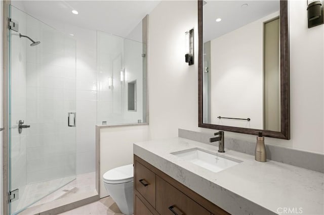 bathroom featuring toilet, a shower with door, and vanity