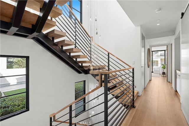 stairs featuring hardwood / wood-style floors