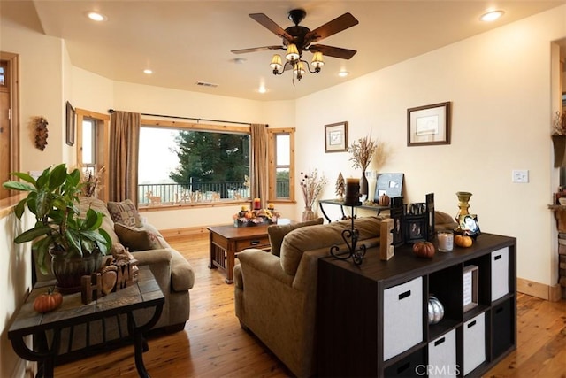 living area with recessed lighting, visible vents, ceiling fan, wood finished floors, and baseboards