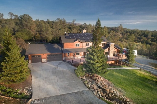 birds eye view of property featuring a wooded view