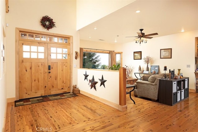 foyer entrance featuring light wood-style floors, recessed lighting, and baseboards