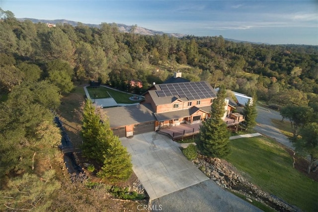 drone / aerial view featuring a forest view