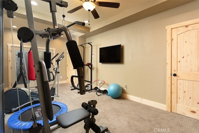 workout area with carpet floors, a ceiling fan, and baseboards