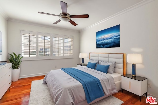 bedroom featuring ceiling fan, crown molding, and hardwood / wood-style floors