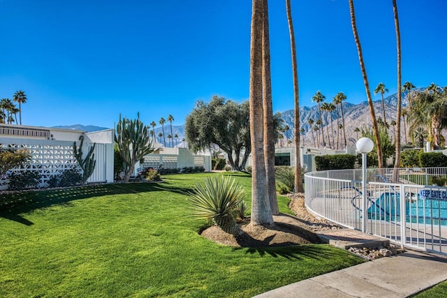 view of yard with a community pool and a mountain view