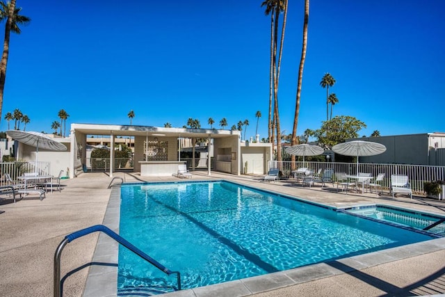 view of pool featuring a community hot tub and a patio area