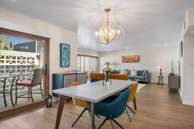 dining room with a notable chandelier and light wood-type flooring