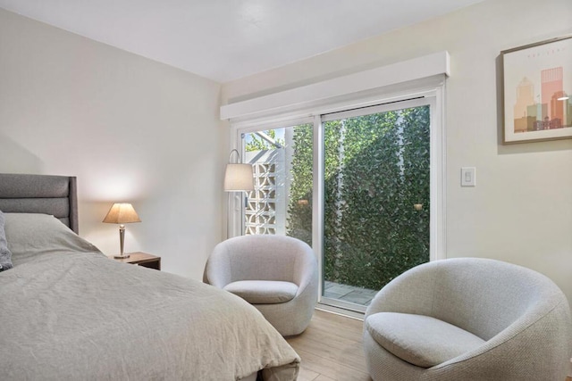 bedroom with access to outside and light wood-type flooring