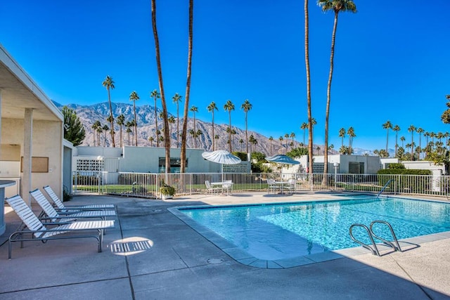 view of pool featuring a mountain view and a patio area