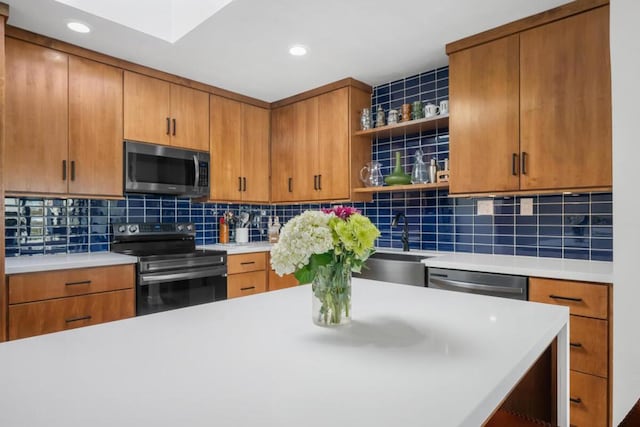 kitchen featuring tasteful backsplash, appliances with stainless steel finishes, and sink