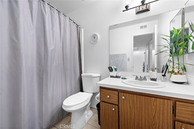 bathroom with toilet, tile patterned floors, and vanity