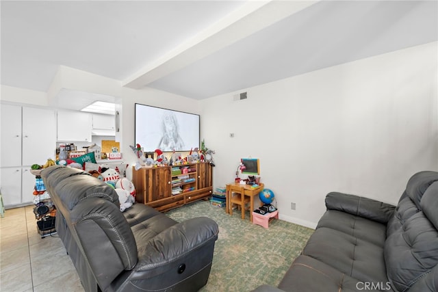 living room featuring light tile patterned floors and beam ceiling