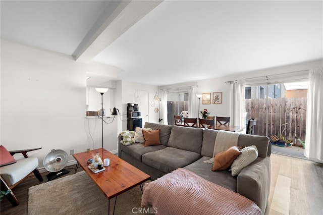 living room featuring wood-type flooring and beam ceiling