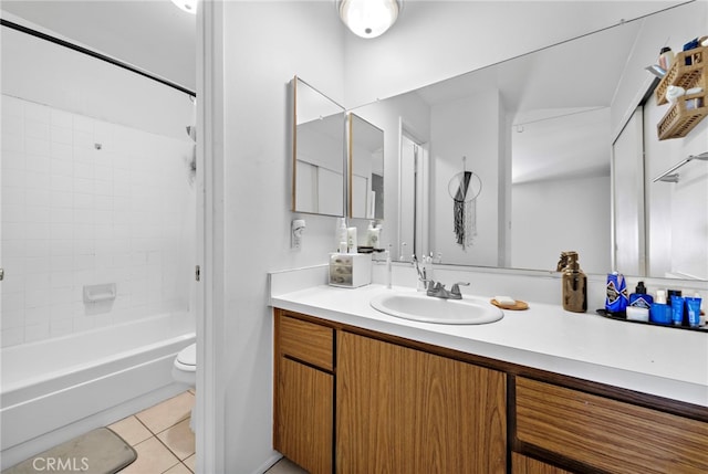 full bathroom with toilet, tiled shower / bath combo, tile patterned floors, and vanity