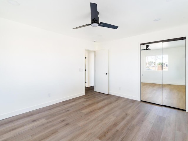 unfurnished bedroom featuring ceiling fan, a closet, and light hardwood / wood-style flooring