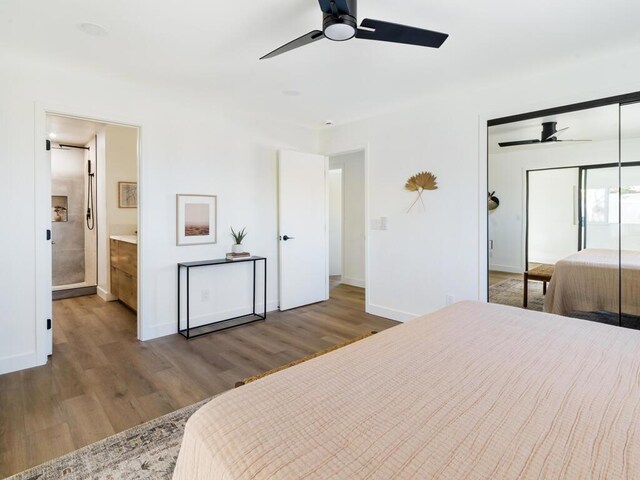 bedroom featuring ceiling fan, connected bathroom, wood-type flooring, and a closet