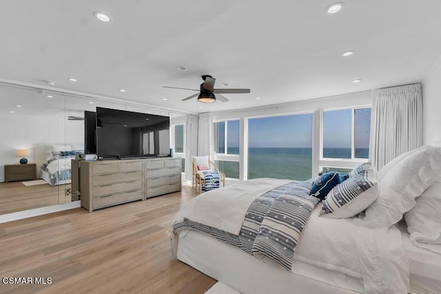 bedroom featuring ceiling fan and light hardwood / wood-style flooring