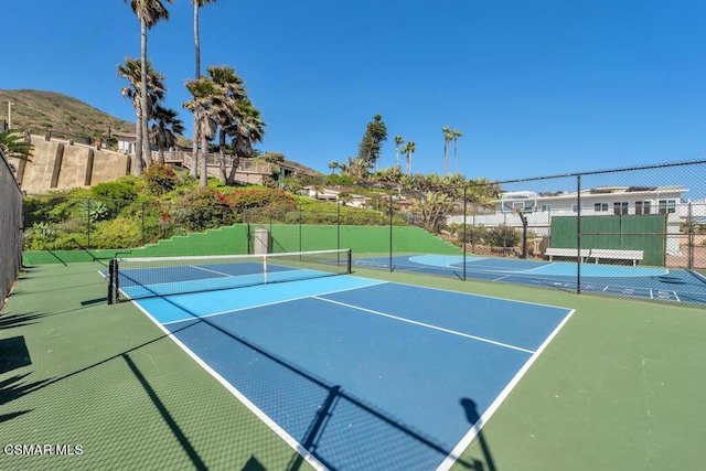 view of sport court featuring basketball court and a mountain view