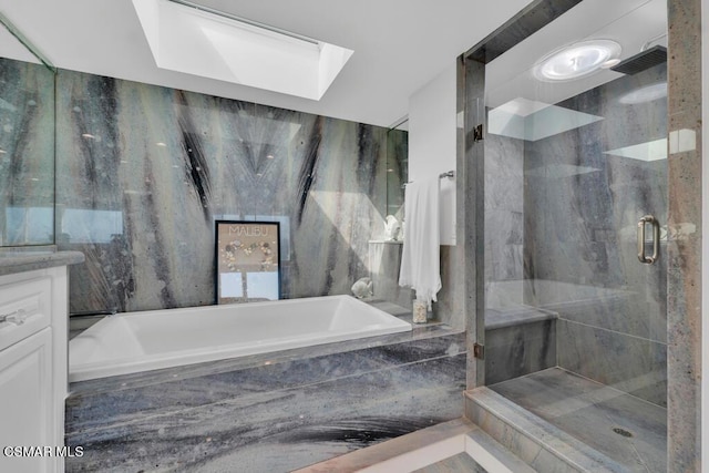 bathroom featuring vanity, a skylight, and plus walk in shower