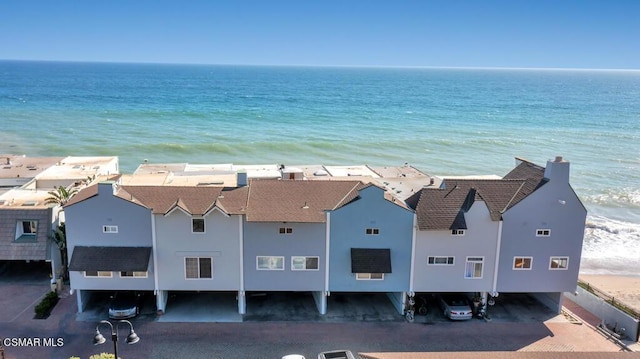 bird's eye view featuring a water view and a beach view