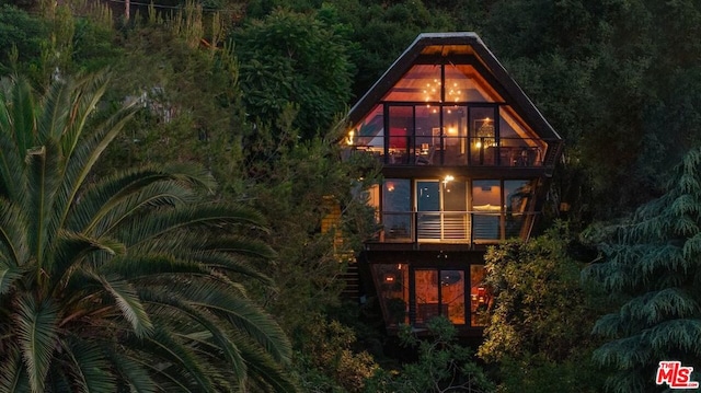 back house at night with a balcony