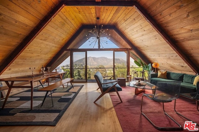 bonus room featuring lofted ceiling with beams, hardwood / wood-style flooring, a mountain view, and wooden ceiling