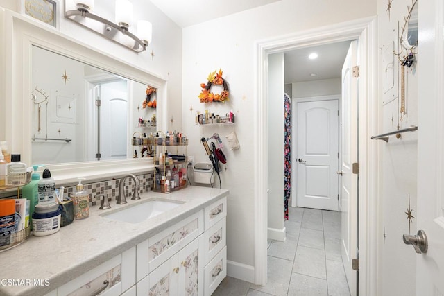 bathroom with tile patterned flooring, backsplash, and vanity