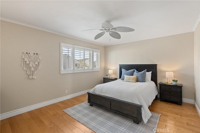 bedroom featuring ceiling fan, light hardwood / wood-style flooring, and ornamental molding