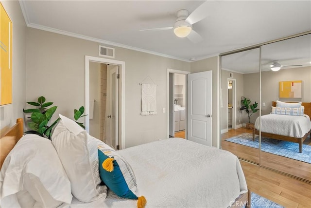 bedroom with hardwood / wood-style flooring, a closet, ceiling fan, ensuite bathroom, and crown molding