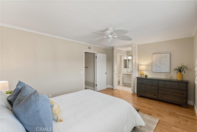 bedroom with ceiling fan, ornamental molding, connected bathroom, and light hardwood / wood-style floors